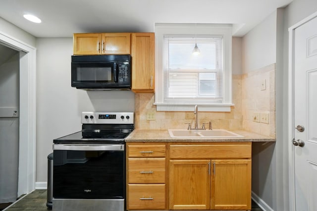 1146 Walters St, Columbus, OH 43201 - kitchen featuring electric range, black microwave, a sink, decorative backsplash, and baseboards