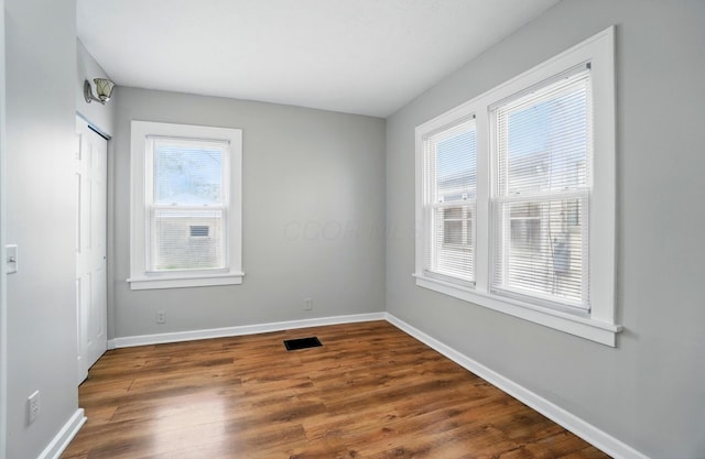 1146 Walters St, Columbus, OH 43201 - unfurnished bedroom with baseboards, dark wood-style flooring, and a closet