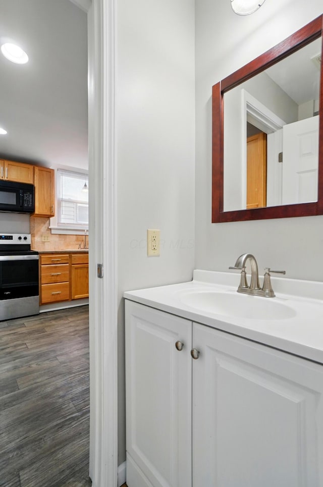 1146 Walters St, Columbus, OH 43201 - bathroom with vanity, wood finished floors, and recessed lighting