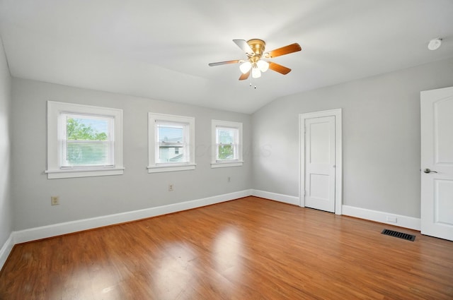 1146 Walters St, Columbus, OH 43201 - unfurnished bedroom featuring multiple windows, wood finished floors, baseboards, vaulted ceiling, and a ceiling fan