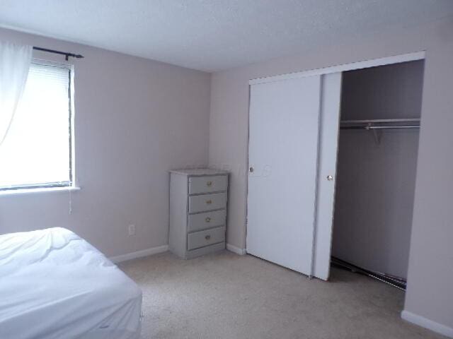1022 Galliton Ct Unit C, Columbus, OH 43220 - carpeted bedroom featuring a closet and baseboards