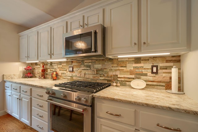 1494 Old Carriage Ct, Canal Winchester, OH 43110 - kitchen featuring stainless steel appliances, white cabinetry, decorative backsplash, and light stone counters