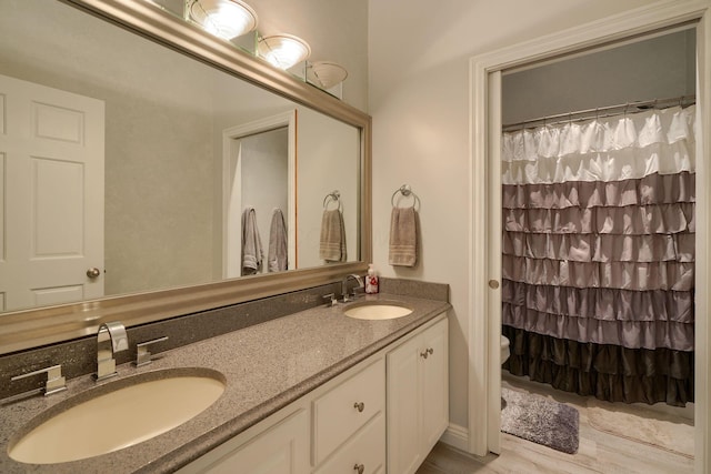 1494 Old Carriage Ct, Canal Winchester, OH 43110 - full bath with double vanity, toilet, a shower with curtain, and wood finished floors