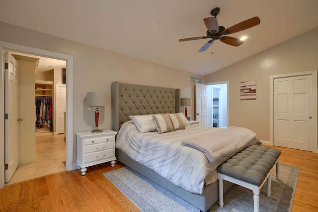 1494 Old Carriage Ct, Canal Winchester, OH 43110 - bedroom featuring light wood-type flooring, a walk in closet, vaulted ceiling, a closet, and ceiling fan