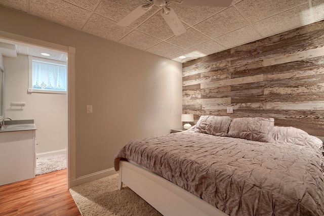1494 Old Carriage Ct, Canal Winchester, OH 43110 - bedroom with wood walls, wood finished floors, a sink, and a ceiling fan