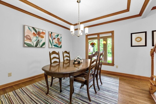5528 Cypress Ct, Westerville, OH 43082 - dining room featuring crown molding, wood finished floors, baseboards, a chandelier, and a tray ceiling