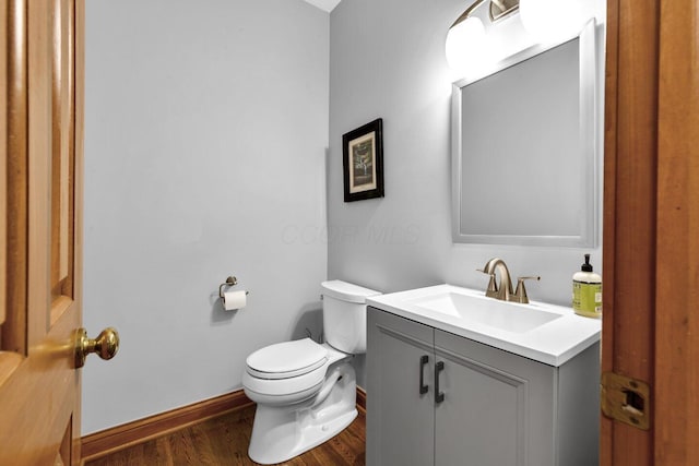 5528 Cypress Ct, Westerville, OH 43082 - half bath featuring vanity, toilet, baseboards, and wood finished floors