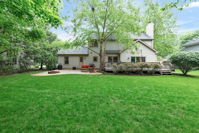 5528 Cypress Ct, Westerville, OH 43082 - rear view of house with a chimney, a fire pit, a deck, a patio area, and a lawn