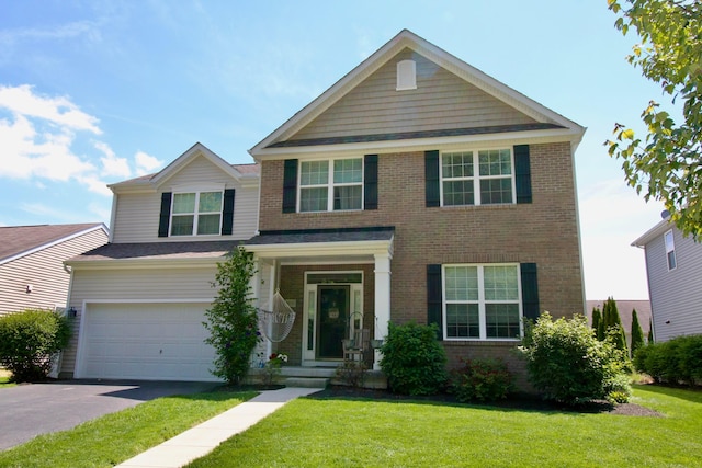 5933 Lakemont Dr, Westerville, OH 43081 - view of front of home featuring driveway, brick siding, a front yard, and an attached garage