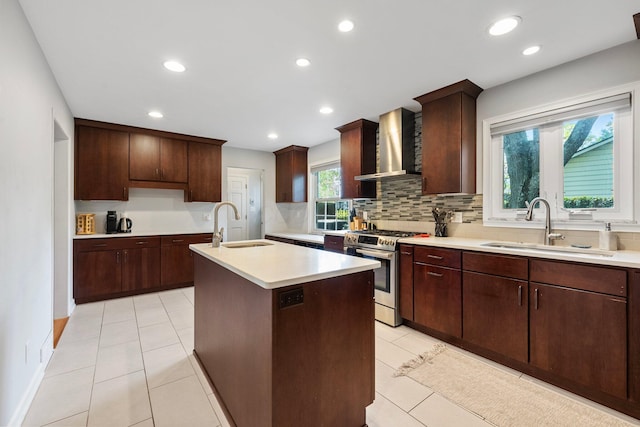 4465 Loos Cir E, Columbus, OH 43214 - kitchen with wall chimney exhaust hood, stainless steel gas range, a sink, backsplash, and recessed lighting