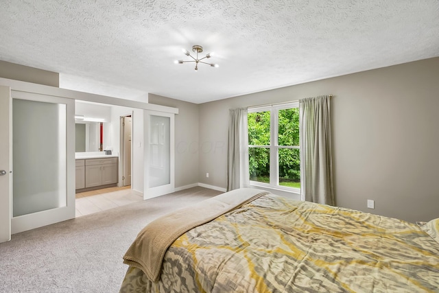 590 Haversham Dr, Gahanna, OH 43230 - bedroom featuring light colored carpet, french doors, connected bathroom, and a textured ceiling