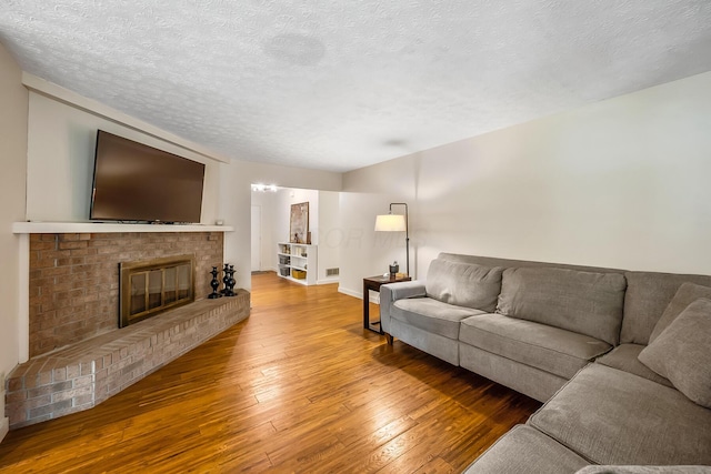 590 Haversham Dr, Gahanna, OH 43230 - living area with hardwood / wood-style flooring, a fireplace, and a textured ceiling