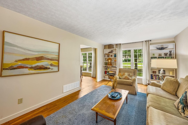 590 Haversham Dr, Gahanna, OH 43230 - living area featuring a textured ceiling, wood finished floors, and plenty of natural light