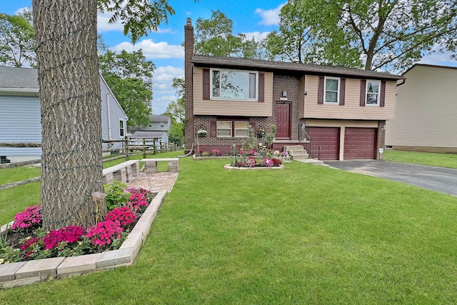 6024 Winterberry Dr, Galloway, OH 43119 - raised ranch with brick siding, asphalt driveway, an attached garage, and a chimney