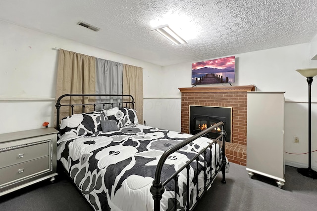 6024 Winterberry Dr, Galloway, OH 43119 - bedroom featuring a textured ceiling, dark carpet, and a brick fireplace