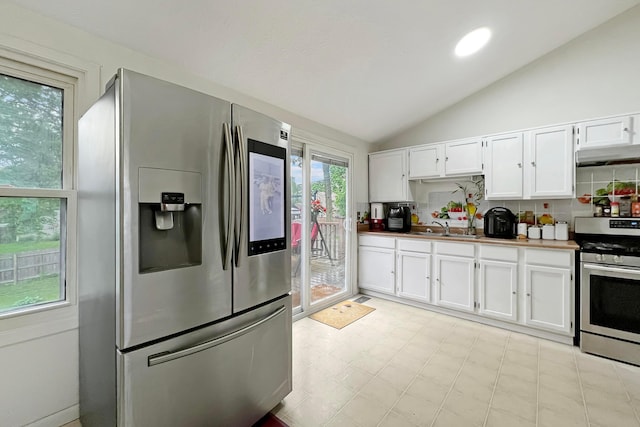 6024 Winterberry Dr, Galloway, OH 43119 - kitchen featuring stainless steel appliances, a sink, lofted ceiling, white cabinetry, and light floors