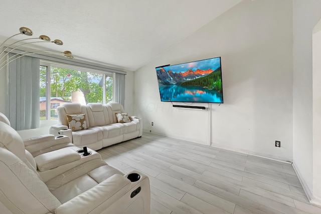 6024 Winterberry Dr, Galloway, OH 43119 - living area with lofted ceiling, light wood-style flooring, and baseboards