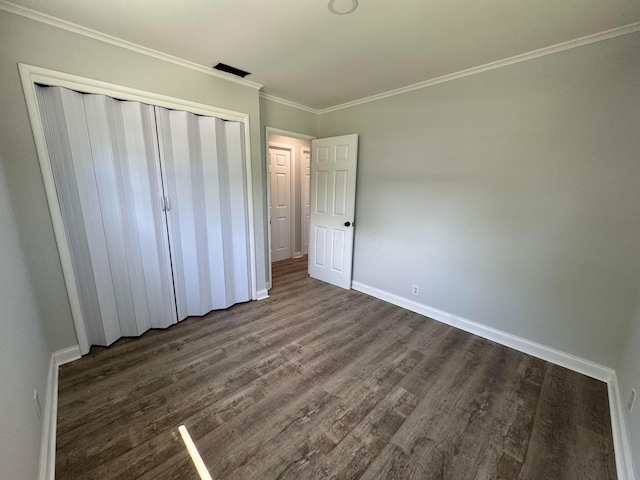 2075 Rankin Ave, Columbus, OH 43219 - unfurnished bedroom featuring dark wood-type flooring, a closet, baseboards, and ornamental molding