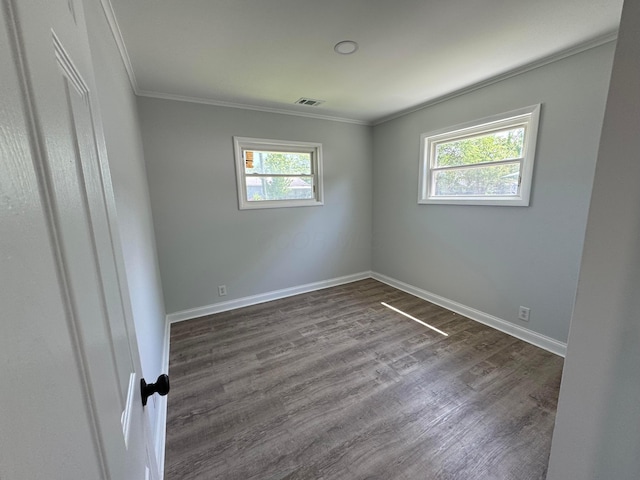2075 Rankin Ave, Columbus, OH 43219 - empty room featuring plenty of natural light, crown molding, dark wood-type flooring, and baseboards