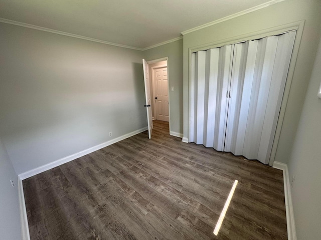 2075 Rankin Ave, Columbus, OH 43219 - unfurnished bedroom with dark wood finished floors, ornamental molding, a closet, and baseboards