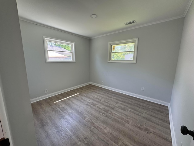 2075 Rankin Ave, Columbus, OH 43219 - empty room with plenty of natural light, crown molding, dark wood-type flooring, and baseboards