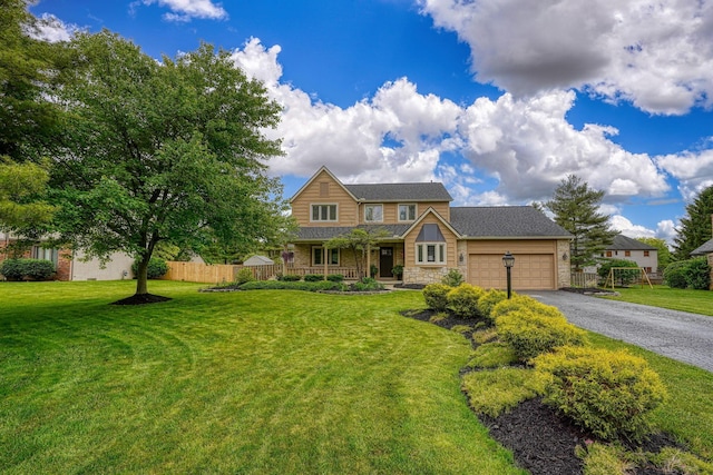 12179 Woodrow Ln, Pickerington, OH 43147 - view of front facade featuring stone siding, a garage, driveway, and covered porch