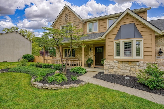 12179 Woodrow Ln, Pickerington, OH 43147 - view of front of house with covered porch, stone siding, brick siding, and a shingled roof