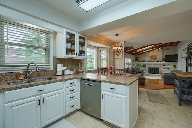12179 Woodrow Ln, Pickerington, OH 43147 - kitchen featuring dishwasher, a sink, a peninsula, a ceiling fan, and a large fireplace