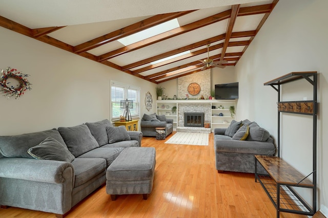 12179 Woodrow Ln, Pickerington, OH 43147 - living area featuring light wood-style flooring, a ceiling fan, and a fireplace