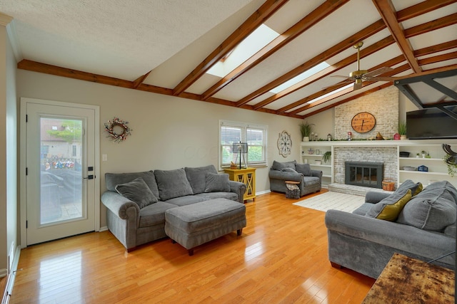 12179 Woodrow Ln, Pickerington, OH 43147 - living area featuring light wood-style flooring, a fireplace, ceiling fan, and baseboards