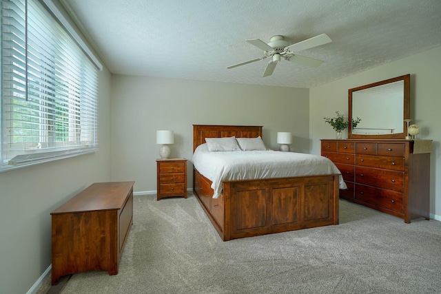 12179 Woodrow Ln, Pickerington, OH 43147 - bedroom with light carpet, a textured ceiling, ceiling fan, and baseboards