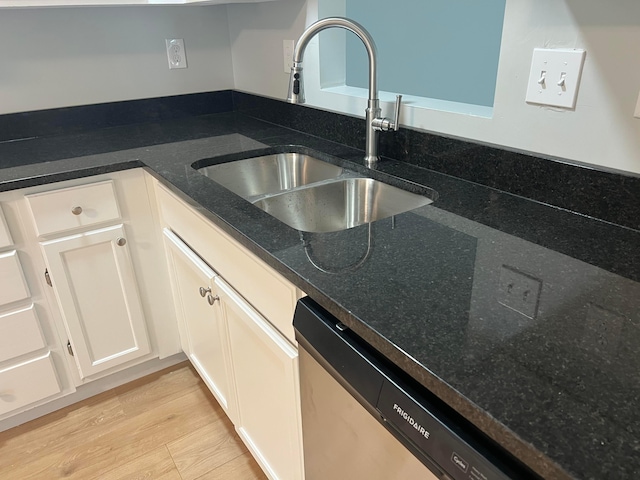 507 Warwick Ln, Pickerington, OH 43147 - kitchen featuring a sink, dishwasher, white cabinets, dark stone countertops, and light wood-style floors