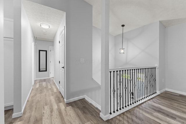 7263 Saddletree Ct, Reynoldsburg, OH 43068 - corridor featuring wood finished floors, baseboards, and a textured ceiling