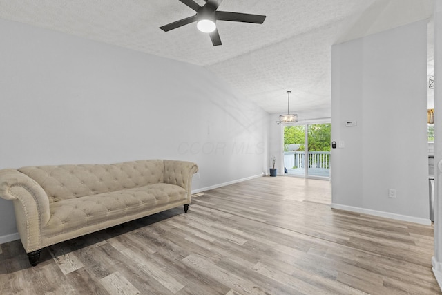 7263 Saddletree Ct, Reynoldsburg, OH 43068 - sitting room featuring a textured ceiling, a ceiling fan, baseboards, light wood-style flooring, and lofted ceiling