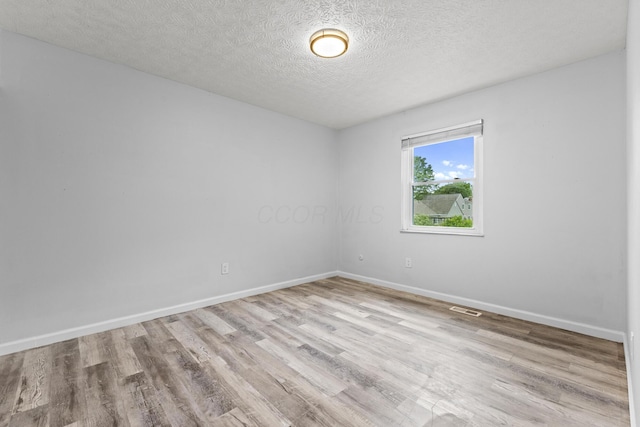 7263 Saddletree Ct, Reynoldsburg, OH 43068 - spare room with wood finished floors, baseboards, and a textured ceiling