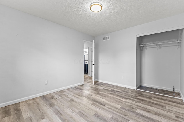 7263 Saddletree Ct, Reynoldsburg, OH 43068 - unfurnished bedroom featuring wood finished floors, a closet, baseboards, and a textured ceiling