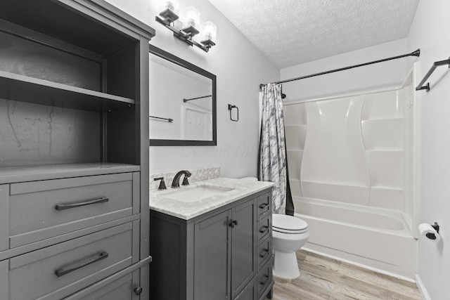 7263 Saddletree Ct, Reynoldsburg, OH 43068 - bathroom featuring vanity, wood finished floors, toilet, shower / bathtub combination with curtain, and a textured ceiling