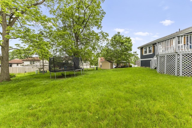 7263 Saddletree Ct, Reynoldsburg, OH 43068 - view of yard with a trampoline and a wooden deck