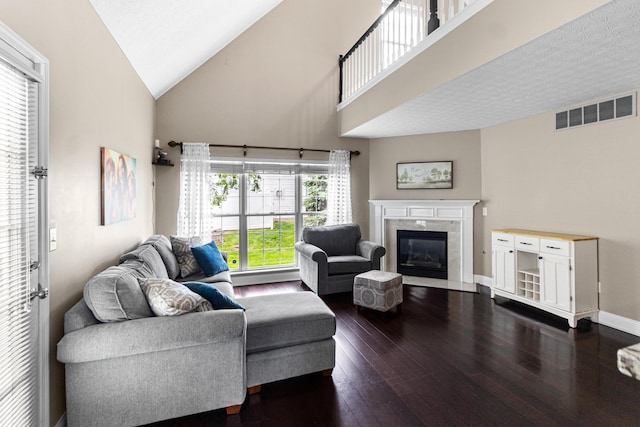 8699 Lazelle Commons Dr, Lewis Center, OH 43035 - living room featuring a fireplace, dark wood-style flooring, high vaulted ceiling, and baseboards