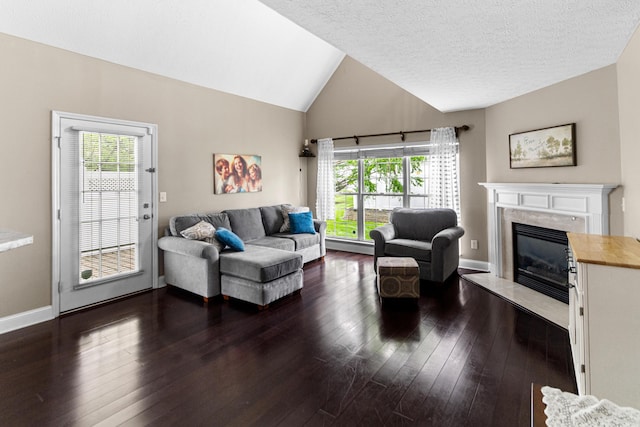 8699 Lazelle Commons Dr, Lewis Center, OH 43035 - living room featuring vaulted ceiling, a fireplace, dark wood-style flooring, a textured ceiling, and baseboards