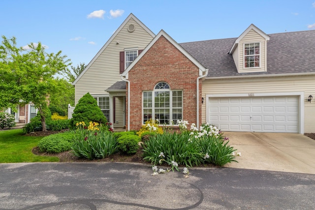 8699 Lazelle Commons Dr, Lewis Center, OH 43035 - view of front of property with brick siding, concrete driveway, a garage, and roof with shingles