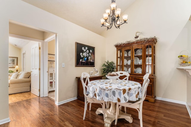 6681 Lakeview Cir, Canal Winchester, OH 43110 - dining room with vaulted ceiling, wood finished floors, a chandelier, and baseboards