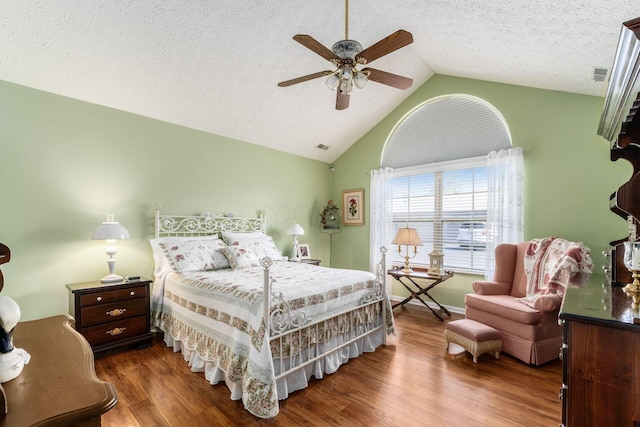 6681 Lakeview Cir, Canal Winchester, OH 43110 - bedroom with vaulted ceiling, wood finished floors, ceiling fan, and a textured ceiling