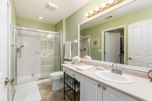 6681 Lakeview Cir, Canal Winchester, OH 43110 - full bath featuring a shower stall, toilet, vanity, tile patterned floors, and a textured ceiling