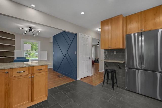 198 Loveman Ave, Worthington, OH 43085 - kitchen featuring freestanding refrigerator, dark tile patterned flooring, decorative backsplash, baseboards, and recessed lighting
