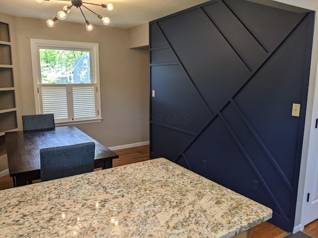 198 Loveman Ave, Worthington, OH 43085 - bedroom featuring wood finished floors, a chandelier, and baseboards