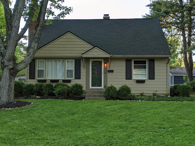 198 Loveman Ave, Worthington, OH 43085 - view of front of home with a chimney, a shingled roof, a front lawn, and entry steps