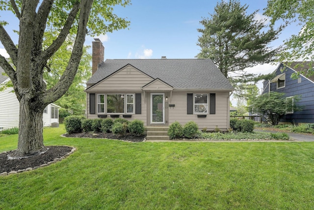 198 Loveman Ave, Worthington, OH 43085 - bungalow-style home with a chimney, roof with shingles, and a front lawn