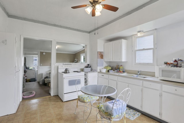 936 Washington Ave, Lancaster, OH 43130 - kitchen featuring white appliances, a sink, light countertops, white cabinetry, and plenty of natural light