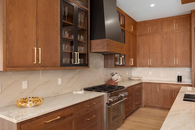 8159 Riverside Dr, Powell, OH 43065 - kitchen with high end stainless steel range, premium range hood, backsplash, and light stone countertops